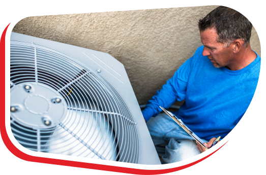 an hvac technician wearing a blue shirt holds a tablet and checks an hvac unit outside