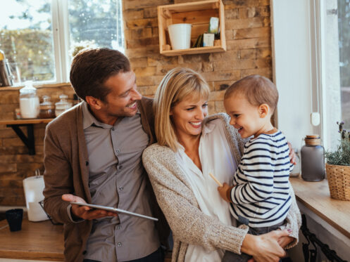 Parents and son using digital tablet at home in Billings.