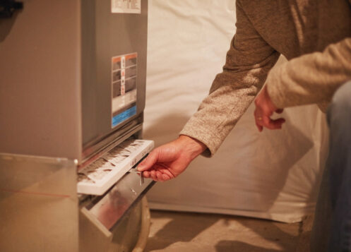 Male home inspector assessing the heating system